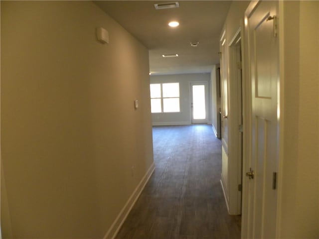 hallway with dark hardwood / wood-style floors