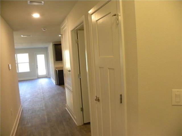 hallway with dark hardwood / wood-style floors