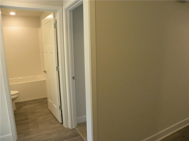 hallway with dark hardwood / wood-style flooring