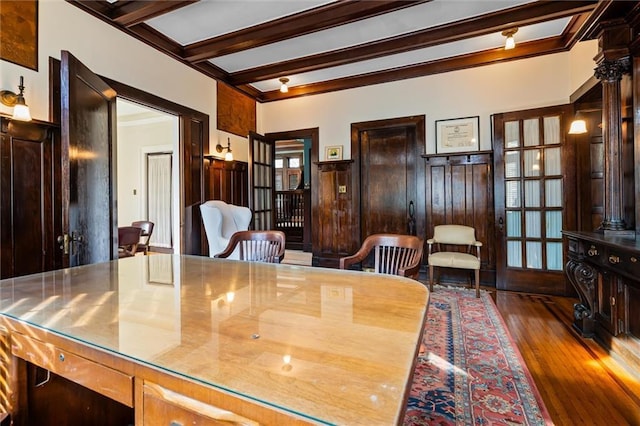 dining room with beam ceiling, dark hardwood / wood-style flooring, and french doors