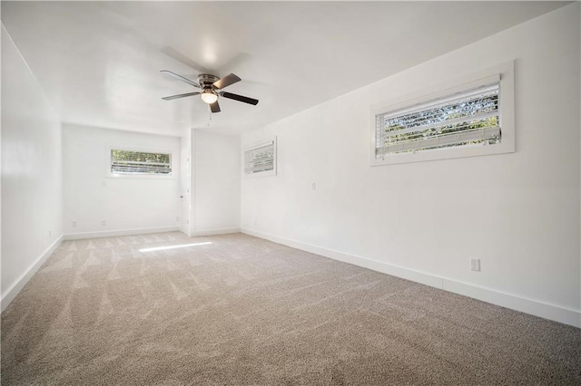 carpeted empty room featuring ceiling fan and a healthy amount of sunlight