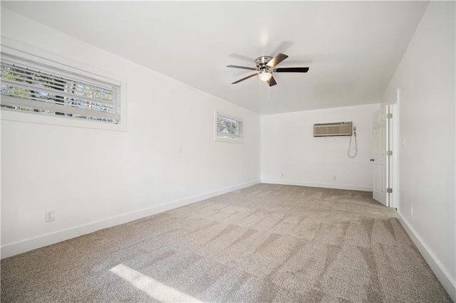 unfurnished room with a wall mounted AC, light carpet, and ceiling fan