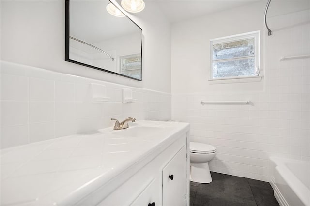 full bathroom featuring vanity, tile patterned floors, toilet, tile walls, and shower / bath combination