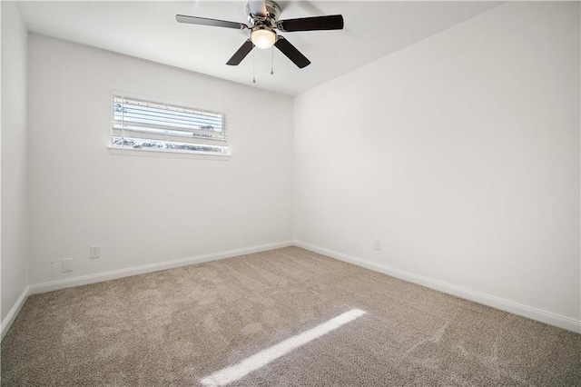 carpeted spare room featuring ceiling fan