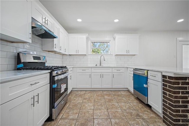 kitchen featuring white cabinets, decorative backsplash, sink, and stainless steel appliances