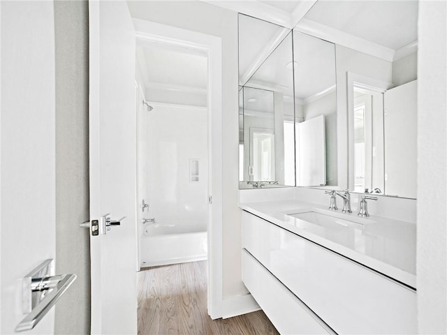 bathroom featuring bathtub / shower combination, hardwood / wood-style flooring, and vanity