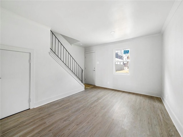 interior space featuring crown molding and light wood-type flooring