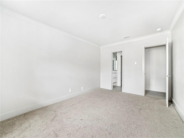 unfurnished bedroom with ornamental molding and light colored carpet