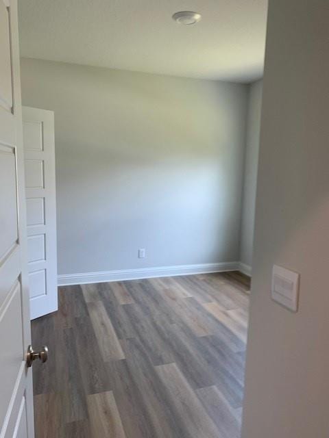 unfurnished room featuring dark hardwood / wood-style flooring