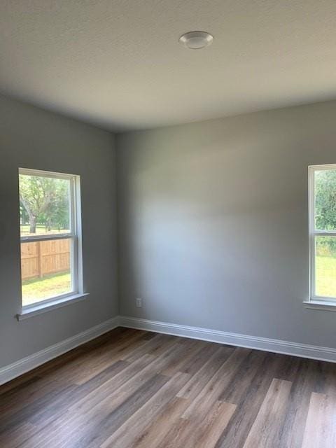 spare room with hardwood / wood-style floors