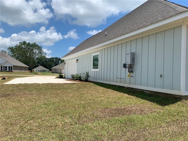 view of home's exterior with a garage and a yard