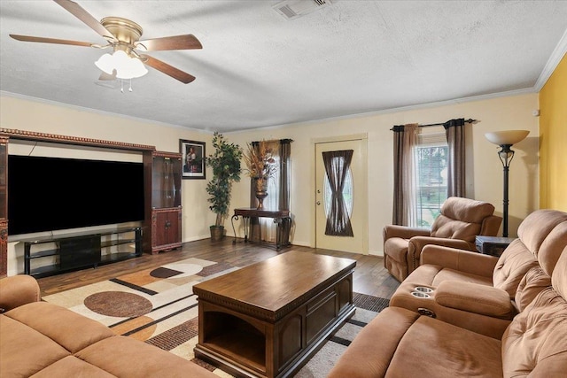 living room with a textured ceiling, light hardwood / wood-style flooring, and ceiling fan