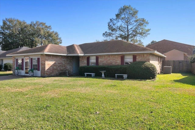 ranch-style house with a front lawn and central AC unit