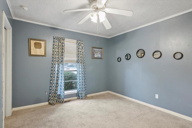 unfurnished room with a textured ceiling, ceiling fan, crown molding, and light carpet