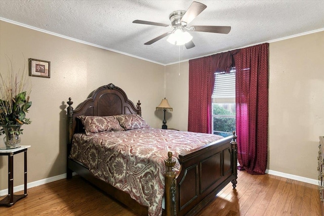 bedroom featuring wood-type flooring, a textured ceiling, ceiling fan, and crown molding