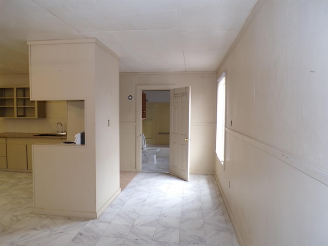 hall featuring marble finish floor and baseboards