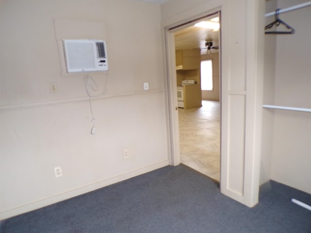 unfurnished room with carpet floors and a wall mounted air conditioner