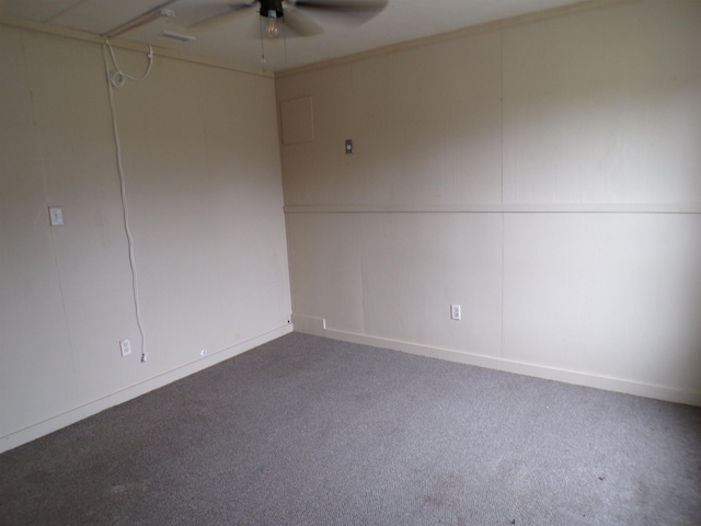 carpeted spare room with a ceiling fan