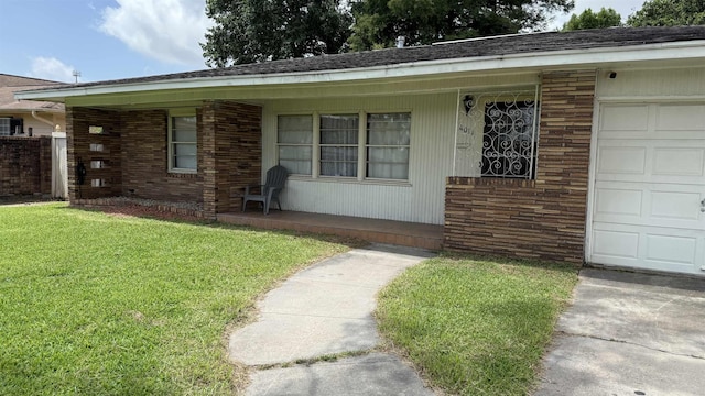 4011 Everglades Ave, Port Arthur, TX 77642 - view of front of house with a front yard, covered porch, brick siding, an attached garage, and driveway