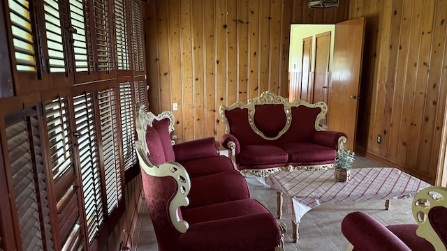 4011 Everglades Ave, Port Arthur, TX 77642 - living area featuring wooden walls and tile patterned flooring