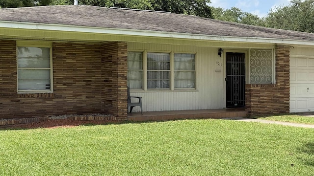4011 Everglades Ave, Port Arthur, TX 77642 - view of front of house with an attached garage, a front yard, a shingled roof, and brick siding