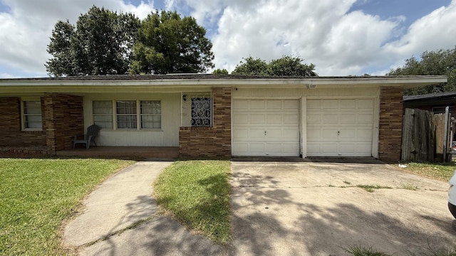 4011 Everglades Ave, Port Arthur, TX 77642 - ranch-style house with concrete driveway, a garage, brick siding, and a front lawn
