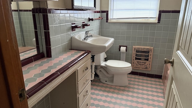 4011 Everglades Ave, Port Arthur, TX 77642 - bathroom featuring heating unit, tile walls, tile patterned floors, a shower, and a wainscoted wall