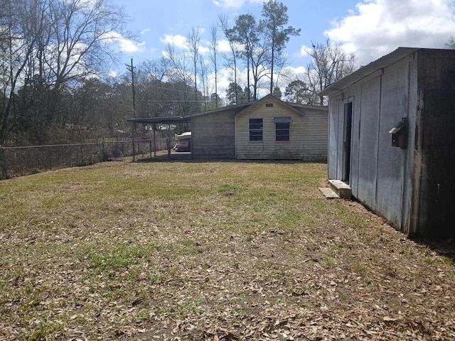 view of yard with an outdoor structure, a storage unit, and fence