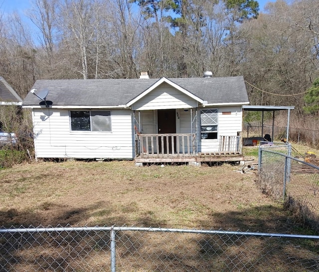 view of front of house featuring fence private yard, a shingled roof, a chimney, and a carport