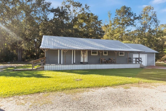 view of front of home with a garage, covered porch, and a front yard