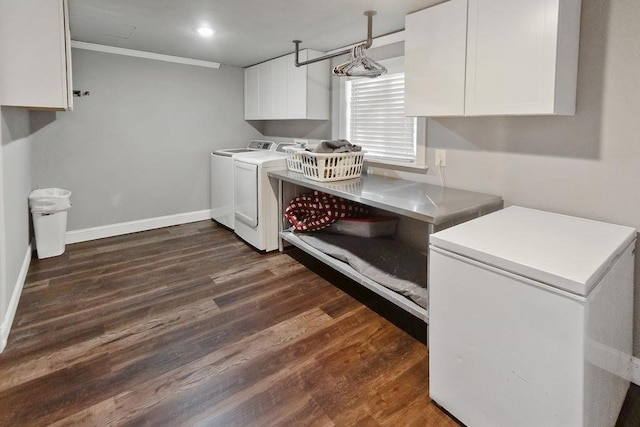 washroom featuring crown molding, cabinets, separate washer and dryer, and dark wood-type flooring