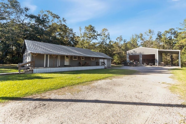 exterior space with a yard, a porch, and a carport