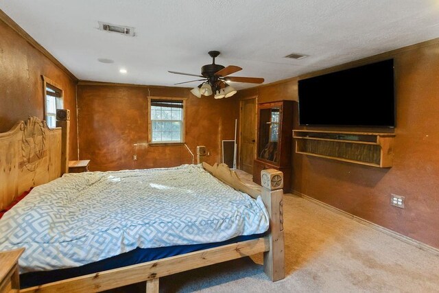 bedroom featuring ceiling fan, crown molding, and light carpet