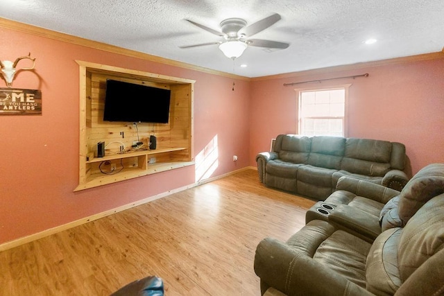 living room featuring ceiling fan, ornamental molding, and light hardwood / wood-style flooring