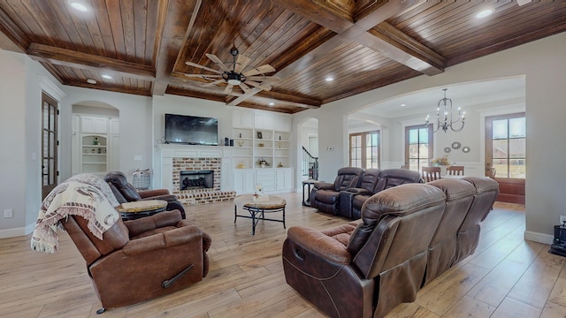 living room with light hardwood / wood-style flooring, wood ceiling, ceiling fan with notable chandelier, and a brick fireplace