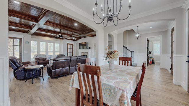 dining space featuring ceiling fan, light hardwood / wood-style floors, beam ceiling, coffered ceiling, and ornamental molding