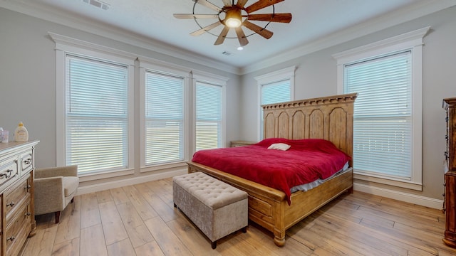 bedroom with ceiling fan, ornamental molding, and light hardwood / wood-style floors