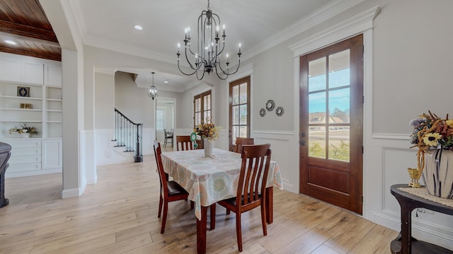 dining area with a wealth of natural light, light hardwood / wood-style floors, and built in features