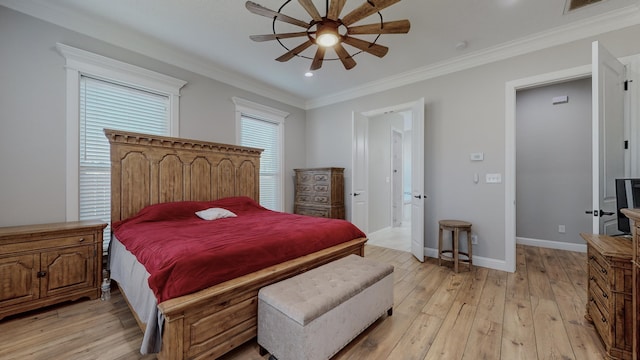 bedroom featuring ceiling fan, light hardwood / wood-style floors, crown molding, and ensuite bath