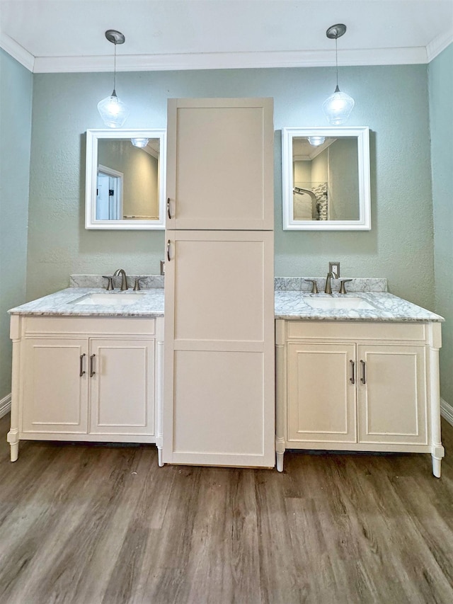 bathroom with wood-type flooring, vanity, and crown molding