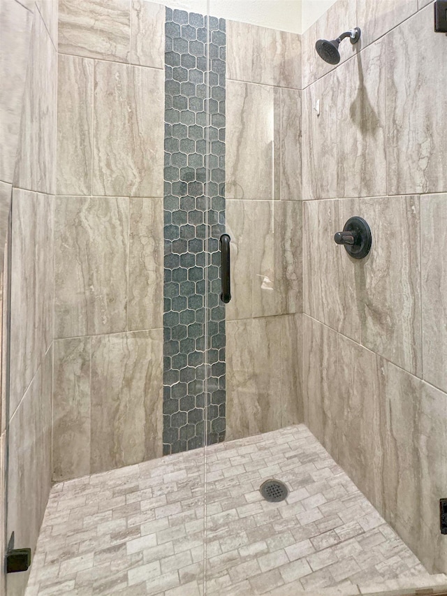 bathroom with a shower with door