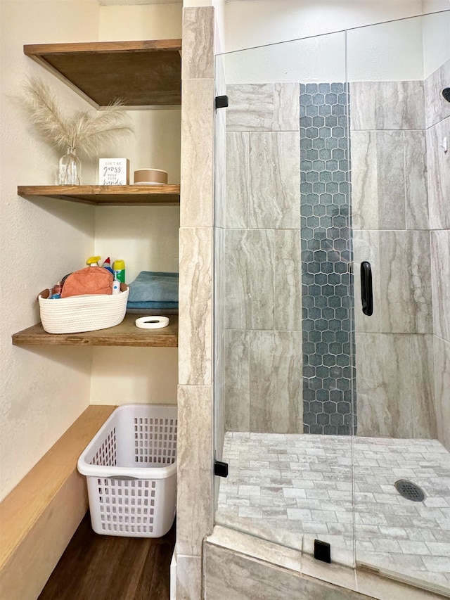 bathroom featuring hardwood / wood-style flooring and walk in shower