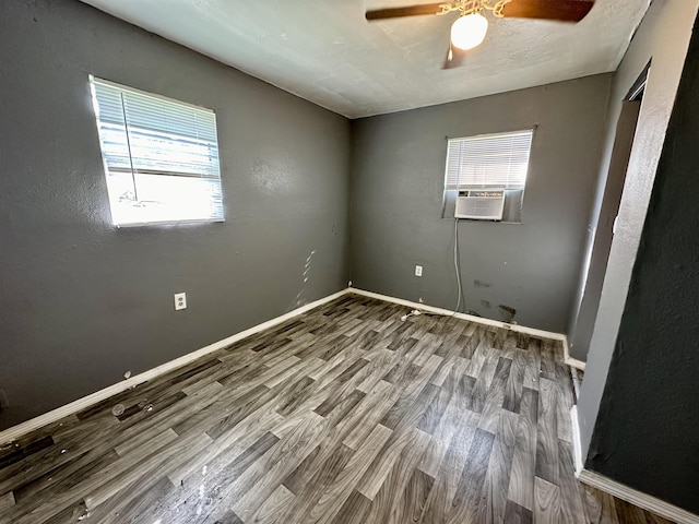 unfurnished room featuring hardwood / wood-style flooring, cooling unit, and ceiling fan