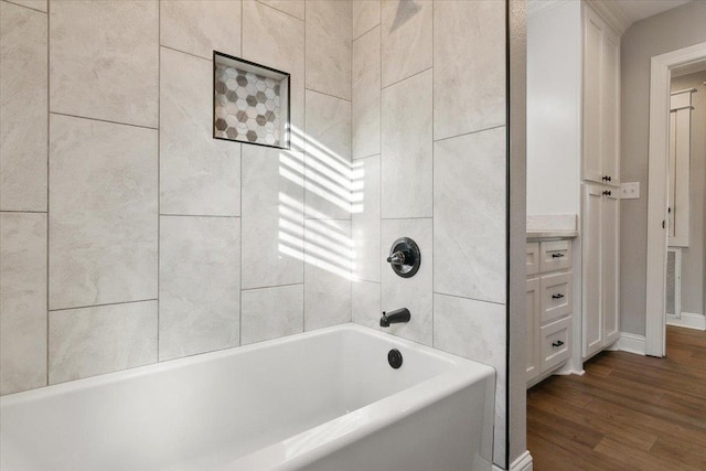 bathroom featuring hardwood / wood-style flooring and tiled shower / bath