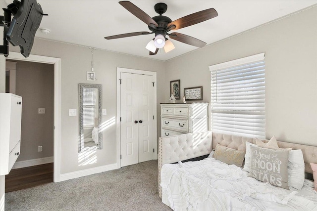 bedroom featuring ceiling fan, light carpet, and a closet