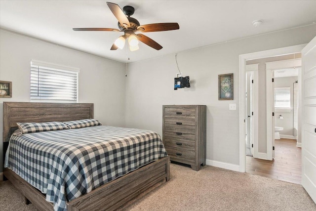 carpeted bedroom featuring ceiling fan and ensuite bathroom