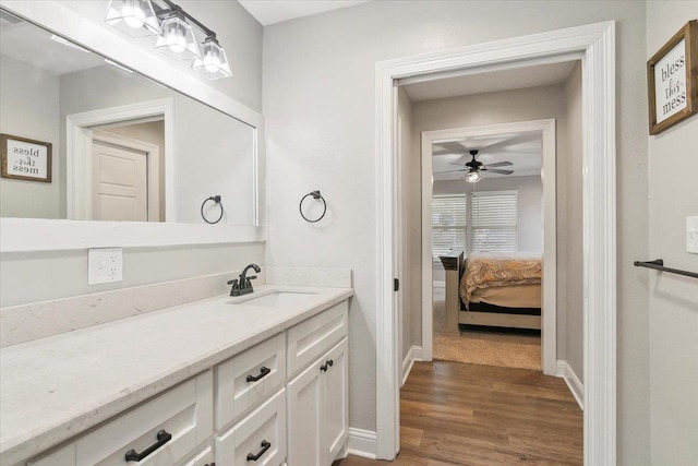 bathroom with ceiling fan, vanity, and wood-type flooring