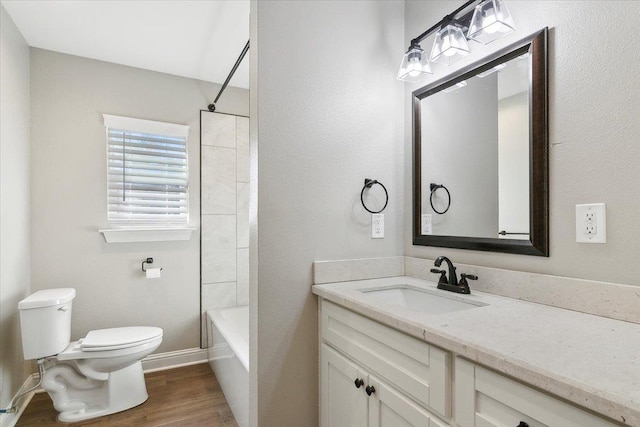 full bathroom featuring shower / bathing tub combination, wood-type flooring, vanity, and toilet