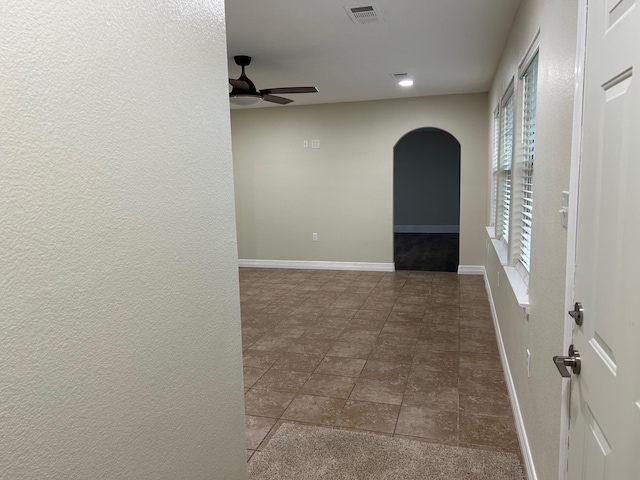 hall with dark tile patterned floors