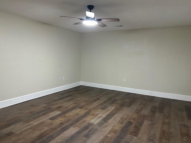 spare room featuring ceiling fan and dark wood-type flooring